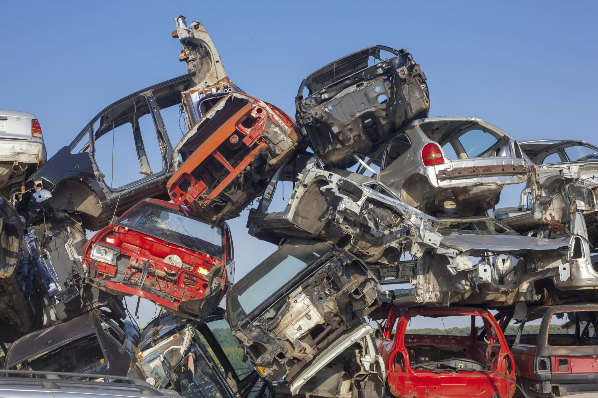 Old cars stack - Car junkyard - damaged vehicles waiting for rec
